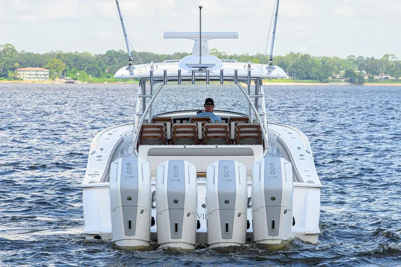 Slide: The Image of 2026 Valhalla V-46 boat with four powerful engines cruising on a serene lake. - 7