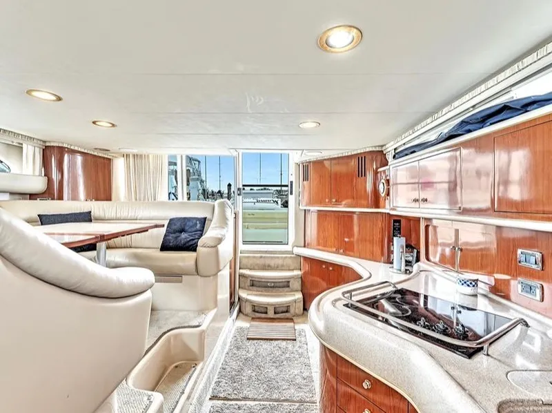 Slide: The Image of Interior of 2002 Sea Ray 450 Express Bridge yacht with luxurious seating and kitchen area. - 27