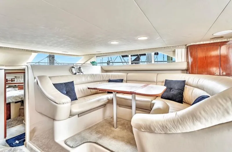 Slide: The Image of Luxurious interior of 2002 Sea Ray 450 Express Bridge yacht with plush seating. - 28