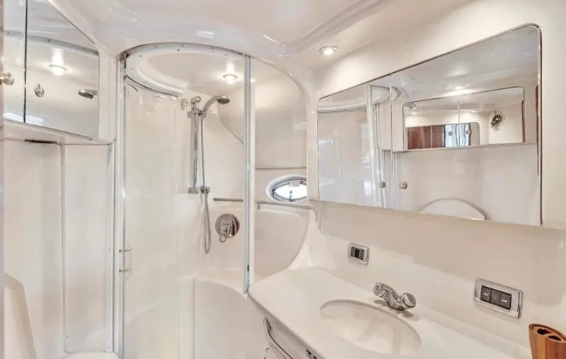 Slide: The Image of 2002 Sea Ray 450 Express Bridge bathroom with modern fixtures and sleek design. - 32
