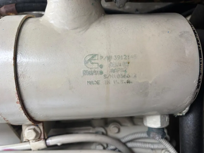 Slide: The Image of Close-up of a Cummins engine part on a 2002 Sea Ray 450 Express Bridge. - 49