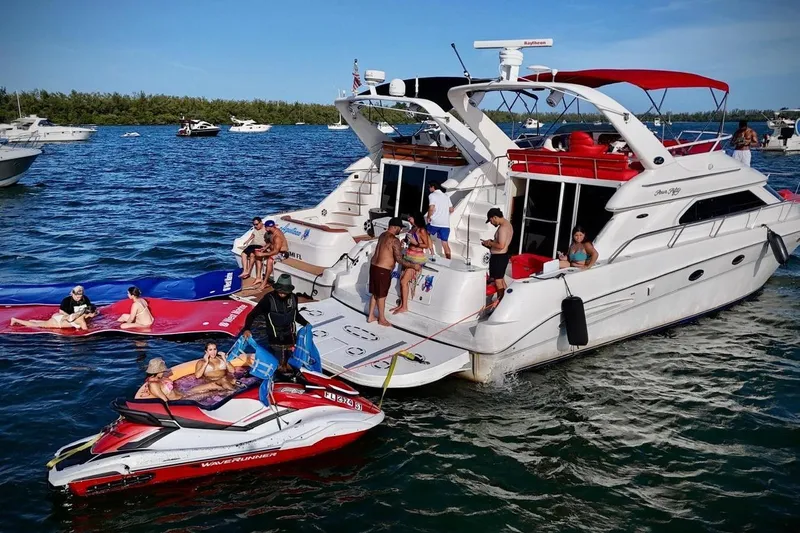 Slide: The Image of People enjoying a day on a 2002 Sea Ray 450 Express Bridge yacht. - 5
