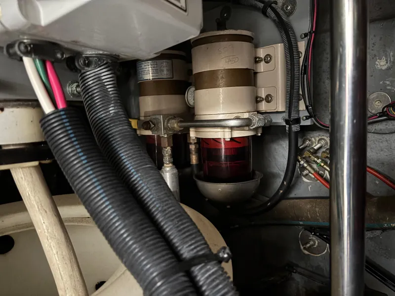 Slide: The Image of Engine compartment of 2002 Sea Ray 450 Express Bridge, showing fuel filters and wiring. - 51