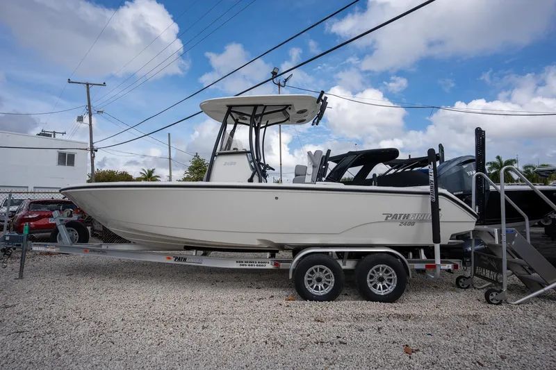 The Image of 2025 Pathfinder 2400 Open boat on trailer, parked outdoors under a blue sky. - 1