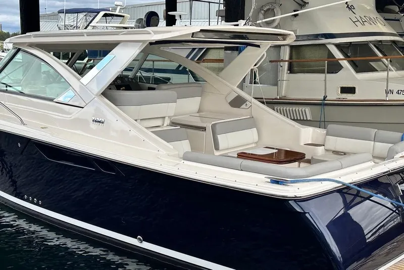 Slide: The Image of 2018 Tiara Yachts 31 model, sleek design, docked in marina, luxurious seating area. - 11