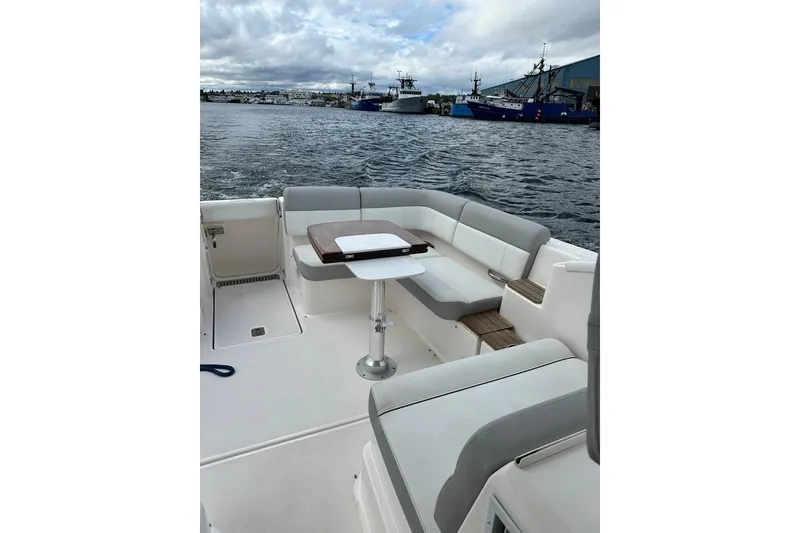 Slide: The Image of 2018 Tiara Yachts 31 boat with spacious seating and table on deck. - 12