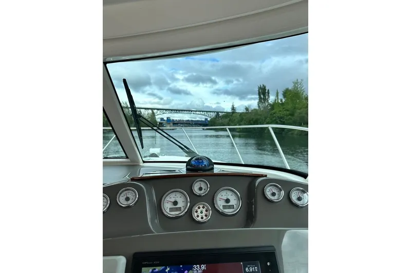 Slide: The Image of Cockpit view from a 2018 Tiara Yachts 31, navigating a scenic river. - 7