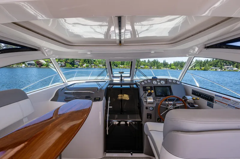Slide: The Image of 2018 Tiara Yachts 3100 Coronet helm with luxurious interior and scenic lake view. - 17