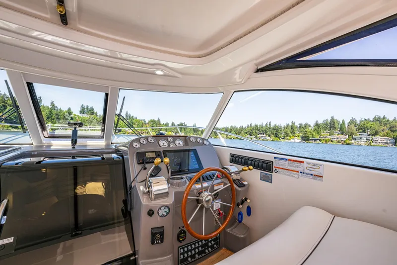 Slide: The Image of 2018 Tiara Yachts 3100 Coronet helm with scenic lake view. - 19