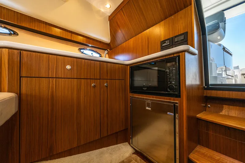 Slide: The Image of Luxurious 2018 Tiara Yachts 31 interior Galley with wood cabinetry and modern appliances. - 21
