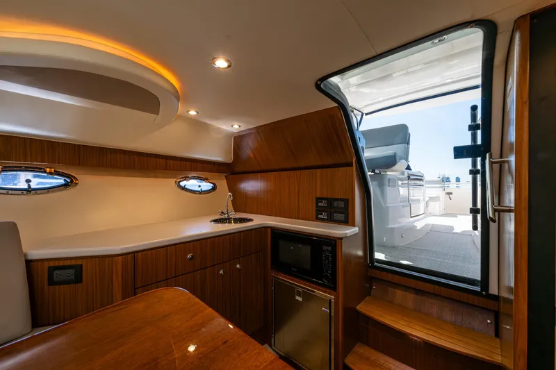 Slide: The Image of Luxurious interior of 2018 Tiara Yachts 3100 Coronet with kitchenette and seating area. - 22
