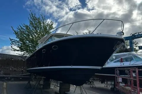 Slide: The Image of 2018 Tiara Yachts 31 boat on dry dock under a cloudy sky. - 25
