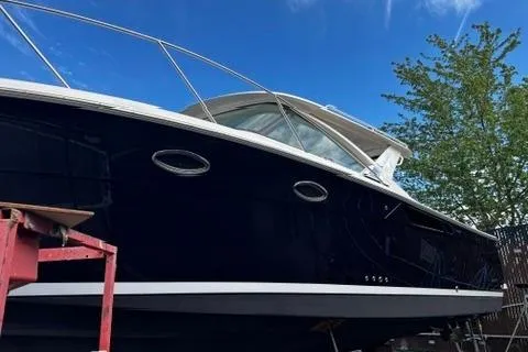 Slide: The Image of 2018 Tiara Yachts 31 boat with sleek design, docked under a clear blue sky. - 28