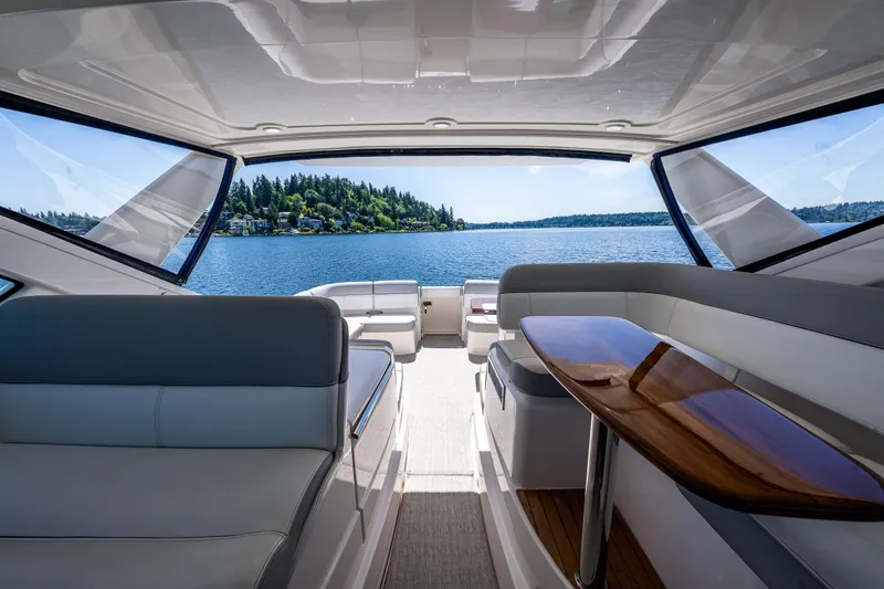 Slide: The Image of Interior view of 2018 Tiara Yachts 3100 Coronet, overlooking serene lake and lush shoreline. - 31