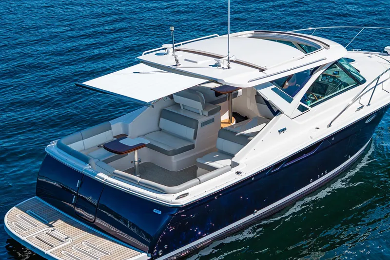 Slide: The Image of 2018 Tiara Yachts 31 model cruising on open water, featuring sleek design and spacious seating. - 4
