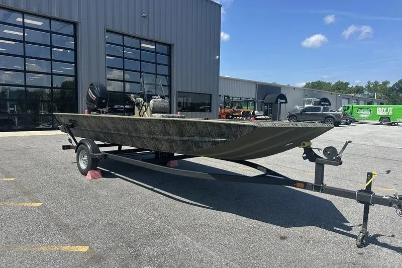 Slide: The Image of 2026 Tracker Grizzly 1860 CC boat on trailer outside dealership. - 6