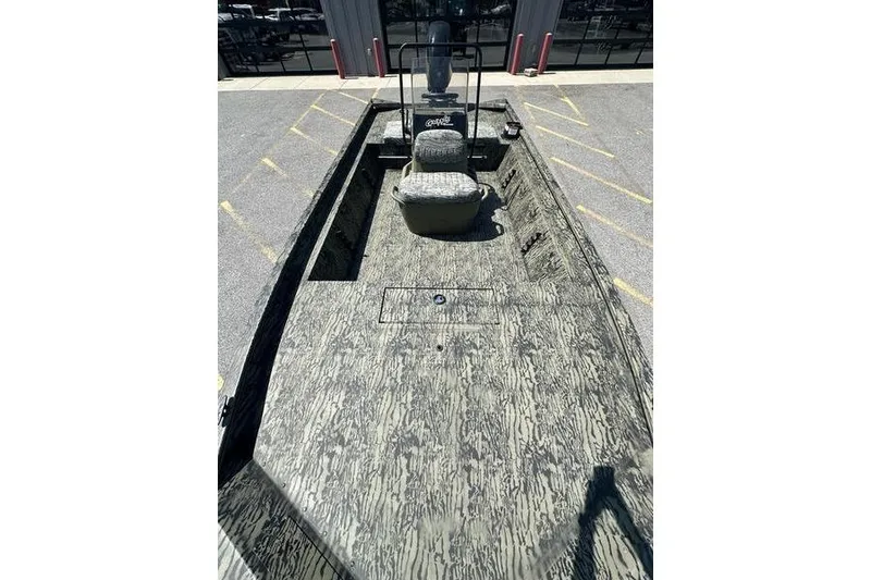 Slide: The Image of 2026 Tracker Grizzly 1860 CC boat with camouflage design, featuring spacious deck and seating. - 7