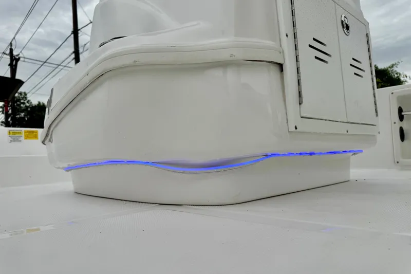 Slide: The Image of 2024 NauticStar 214 Bay boat interior with blue LED lighting detail. - 17