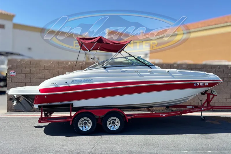 The Image of 2003 Four Winns 214 Funship boat on a trailer, featuring a red and white design. - 0