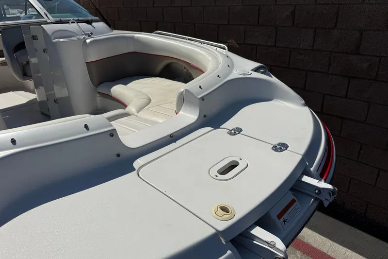 Slide: The Image of 2003 Four Winns 214 Funship boat interior with white seating and red accents. - 10
