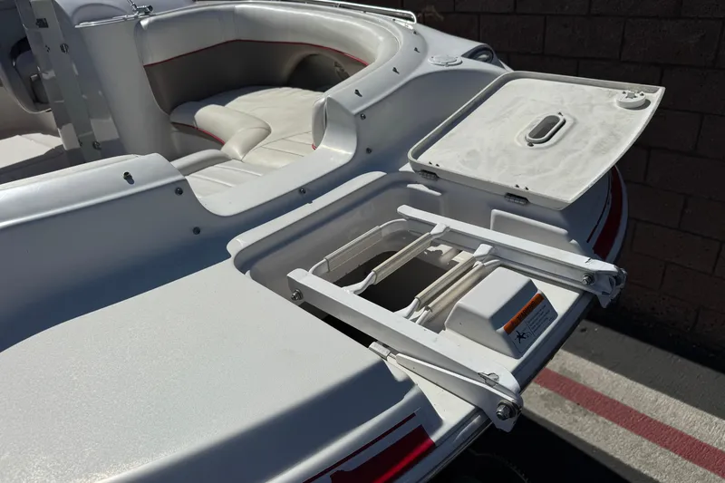 Slide: The Image of 2003 Four Winns 214 Funship boat interior with open storage compartment and seating. - 11