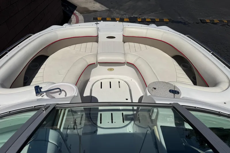 Slide: The Image of 2003 Four Winns 214 Funship boat interior with white seating and red accents. - 12