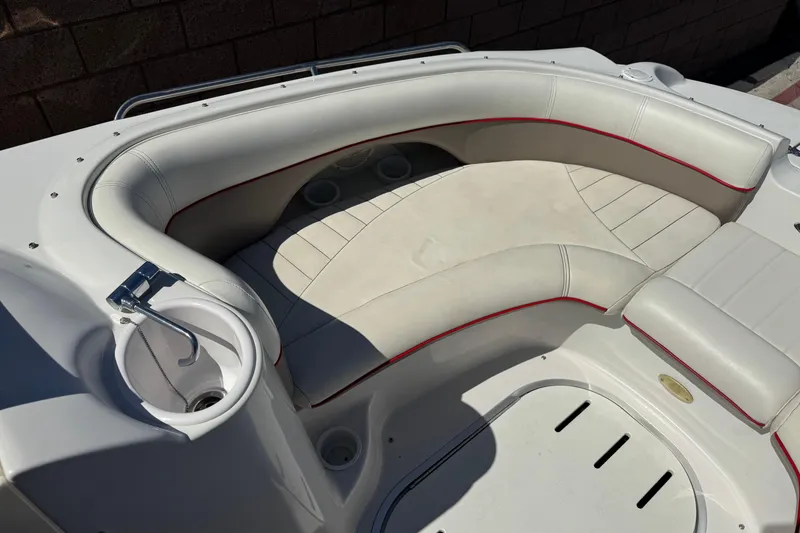 Slide: The Image of 2003 Four Winns 214 Funship boat interior with white seating and red accents. - 13