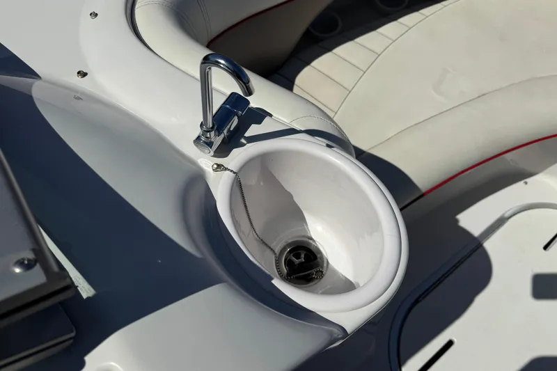 Slide: The Image of 2003 Four Winns 214 Funship boat interior with faucet and seating area. - 14