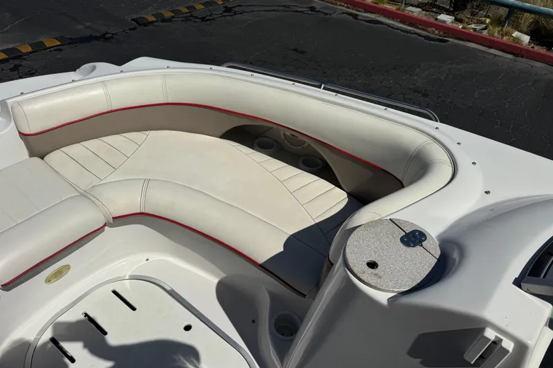Slide: The Image of 2003 Four Winns 214 Funship boat interior with white seating and red accents. - 15