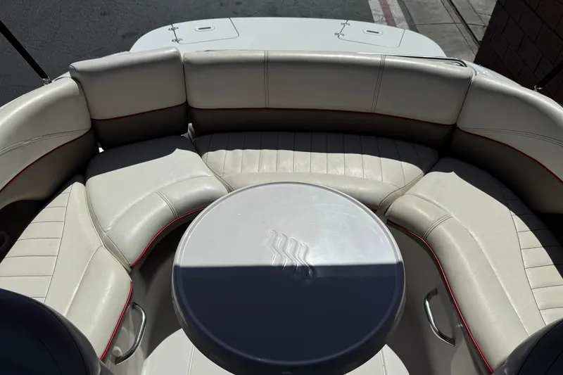 Slide: The Image of 2003 Four Winns 214 Funship boat interior with circular seating and table. - 19