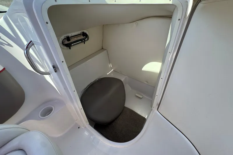 Slide: The Image of 2003 Four Winns 214 Funship boat interior with compact restroom area. - 24
