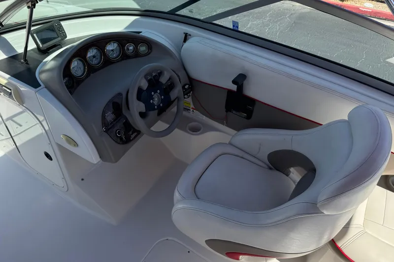Slide: The Image of 2003 Four Winns 214 Funship boat cockpit with steering wheel and gauges. - 25