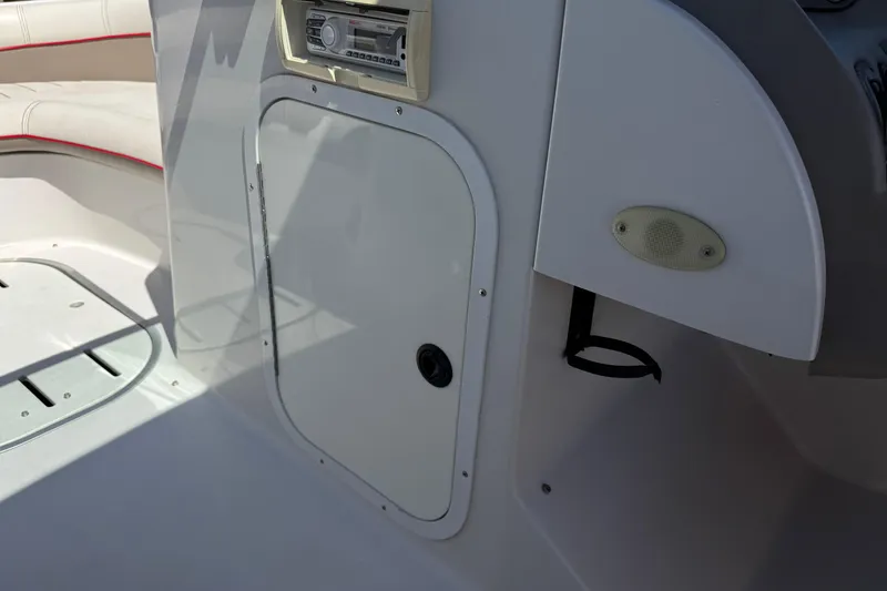 Slide: The Image of 2003 Four Winns 214 Funship interior with storage compartment and audio system. - 28