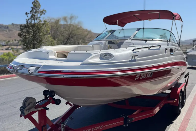 Slide: The Image of 2003 Four Winns 214 Funship boat on trailer, red and white design, parked outdoors. - 3