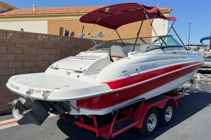 Slide: The Image of 2003 Four Winns 214 Funship boat with red and white design on a trailer. - 5
