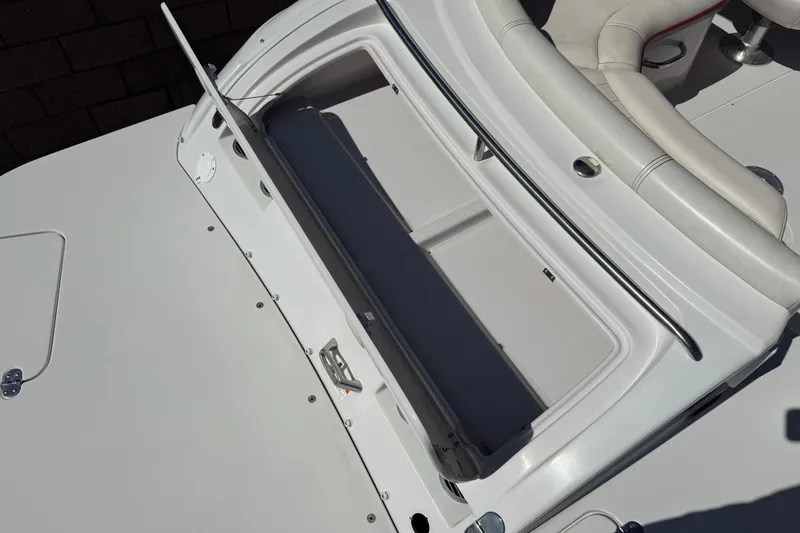 Slide: The Image of 2003 Four Winns 214 Funship boat interior with open storage compartment and seating. - 7