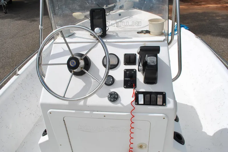 Slide: The Image of Console of a 2007 Blue Wave 180 V-Bay boat with steering wheel and controls. - 21