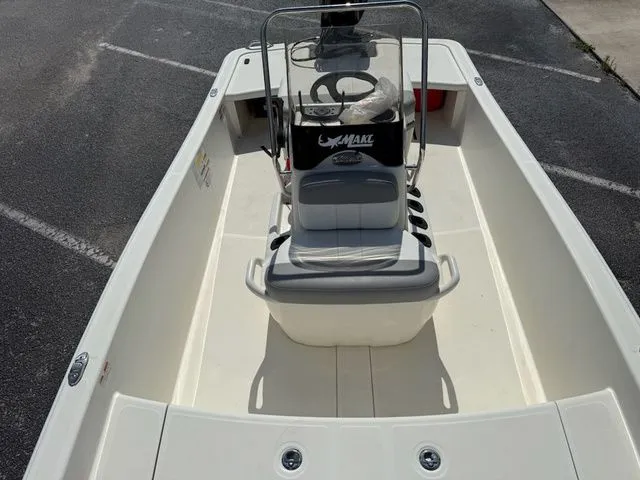 Slide: The Image of 2023 Mako Pro Skiff 15 CC boat, interior view, steering console visible. - 10