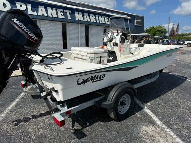 Slide: The Image of 2023 Mako Pro Skiff 15 CC boat on trailer outside marine store. - 4