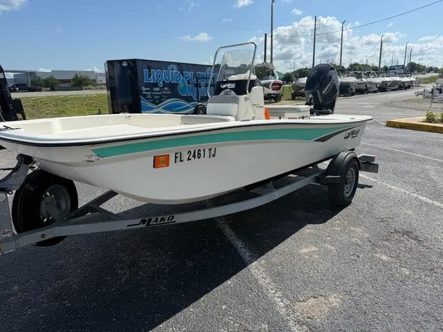 Slide: The Image of 2023 Mako Pro Skiff 15 CC parked on trailer outdoors. - 7