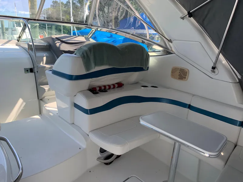 Slide: The Image of 2005 Formula 34 PC boat interior with white and blue seating and small table. - 11
