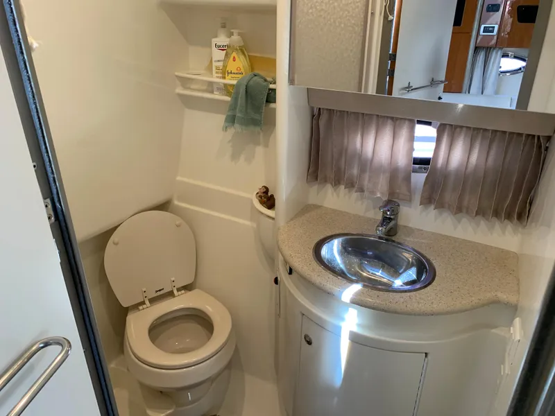 Slide: The Image of 2005 Formula 34 Performance Cruiser bathroom with toilet, sink, and storage shelves. - 31