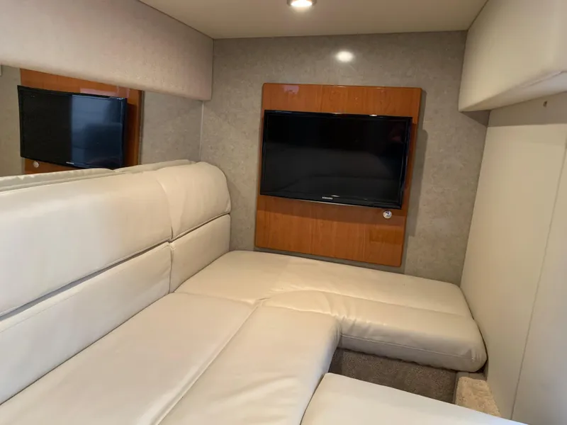 Slide: The Image of 2005 Formula 34 Performance Cruiser interior with beige seating and wall-mounted TV. - 35