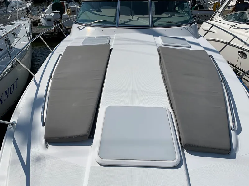 Slide: The Image of 2005 Formula 34 Performance Cruiser with sun pads on deck, docked at marina. - 38