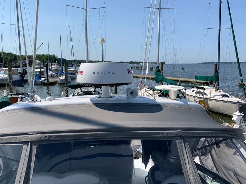 Slide: The Image of 2005 Formula 34 Performance Cruiser docked at marina with sailboats in background. - 40