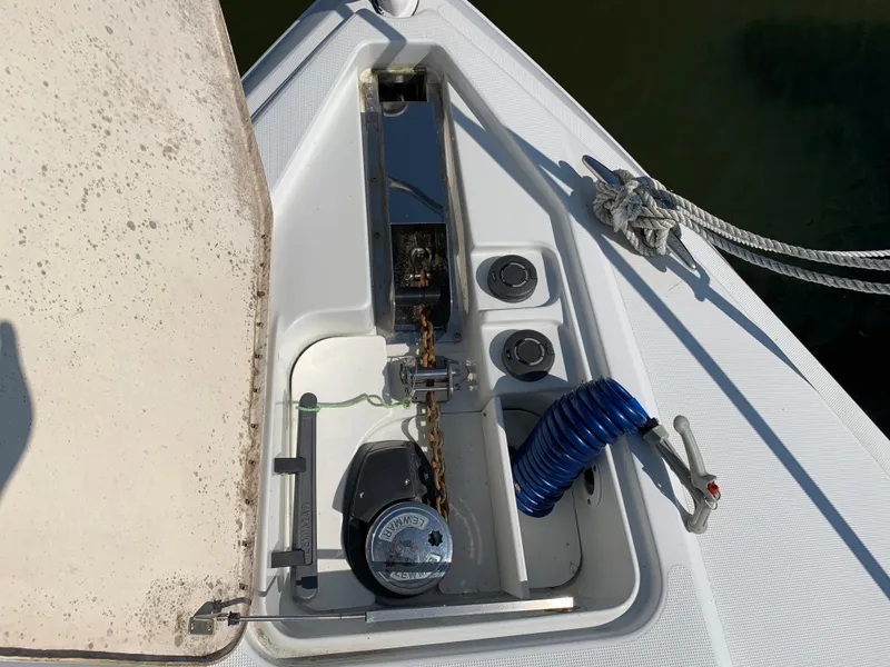 Slide: The Image of Anchor locker of a 2005 Formula 34 Performance Cruiser with coiled hose and winch. - 42