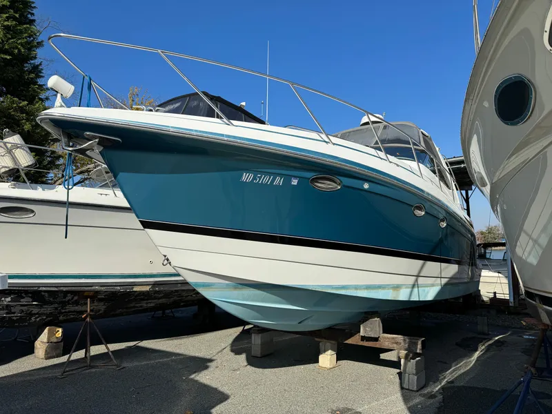 Slide: The Image of 2005 Formula 34 Performance Cruiser boat on dry dock, blue and white hull, sunny day. - 46