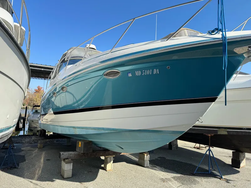 Slide: The Image of 2005 Formula 34 Performance Cruiser boat on stands, blue hull, docked outdoors. - 47