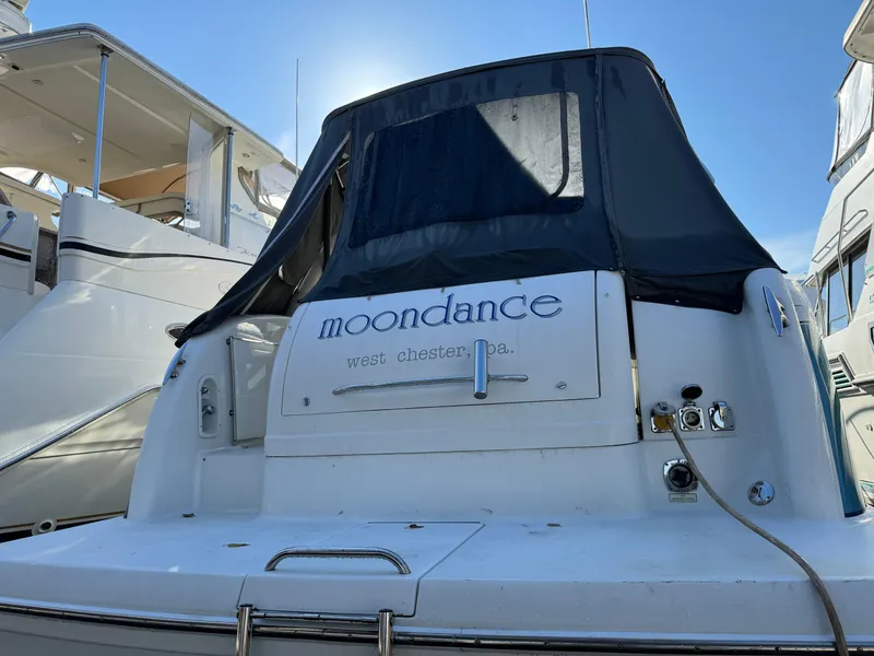 Slide: The Image of 2005 Formula 34 Performance Cruiser named "Moondance" docked under clear blue sky. - 49
