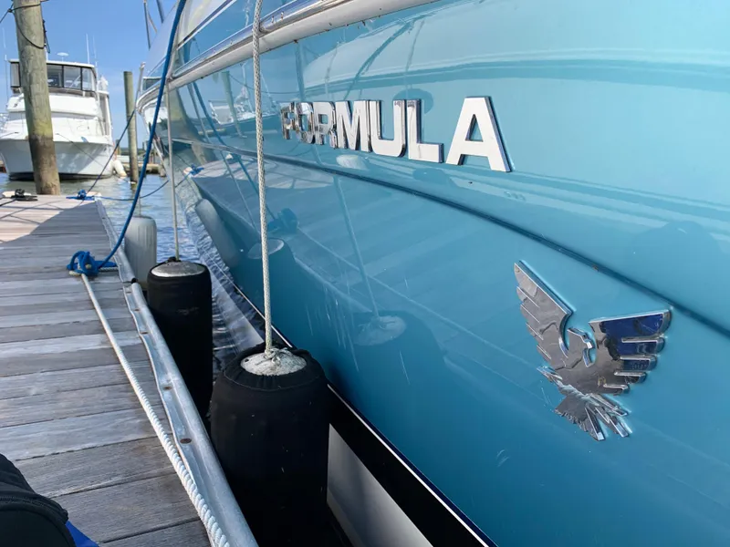 Slide: The Image of 2005 Formula 34 PC boat docked at marina, side view. - 5